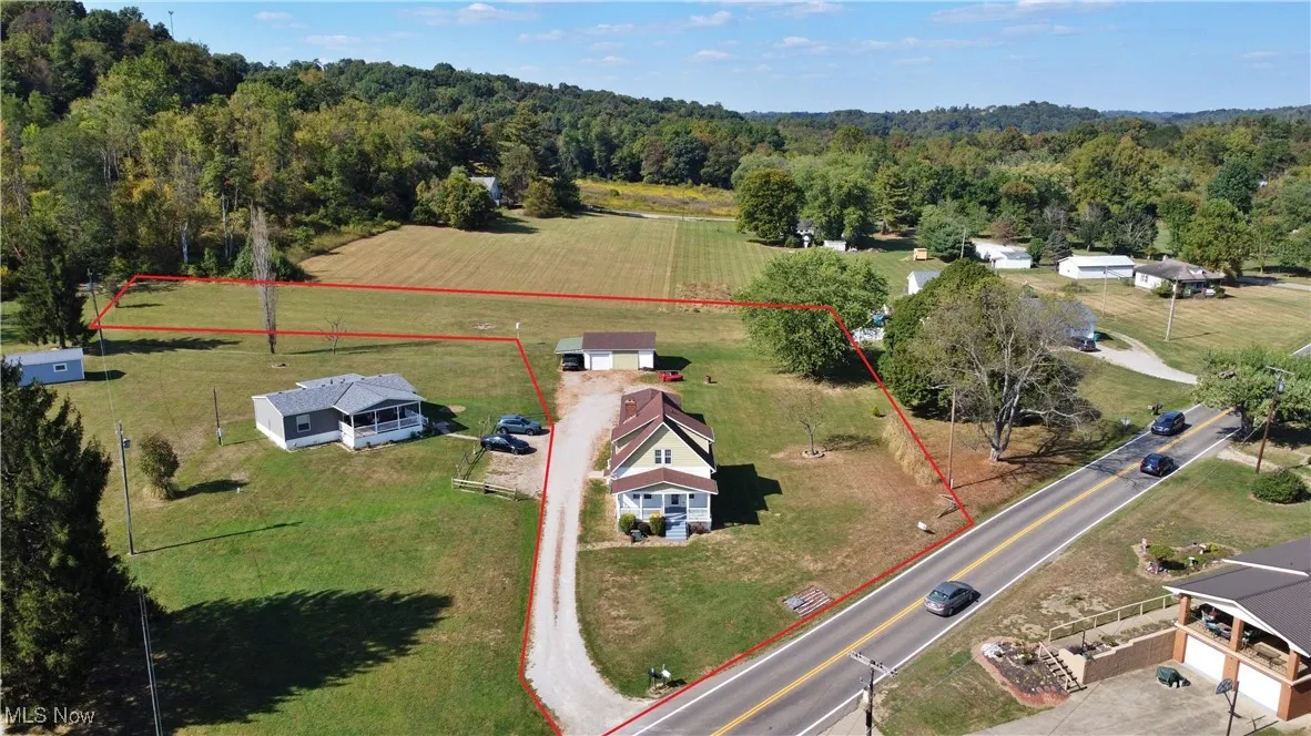 Aerial view of sparsely populated area with a heavily wooded area and property boundaries highlighted