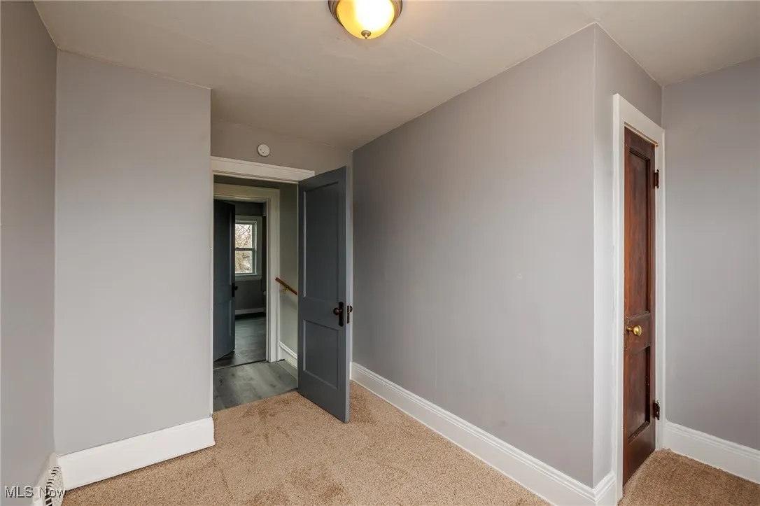 Hall with carpet and baseboards