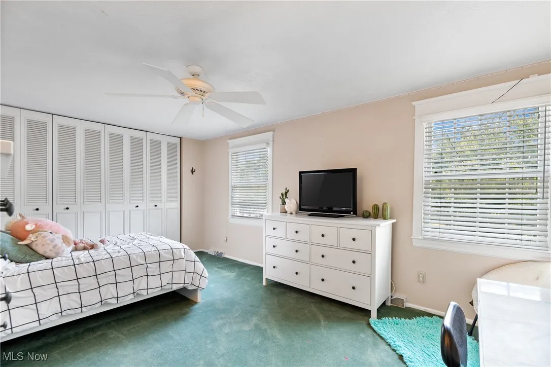 Bedroom featuring a closet, carpet floors, and ceiling fan