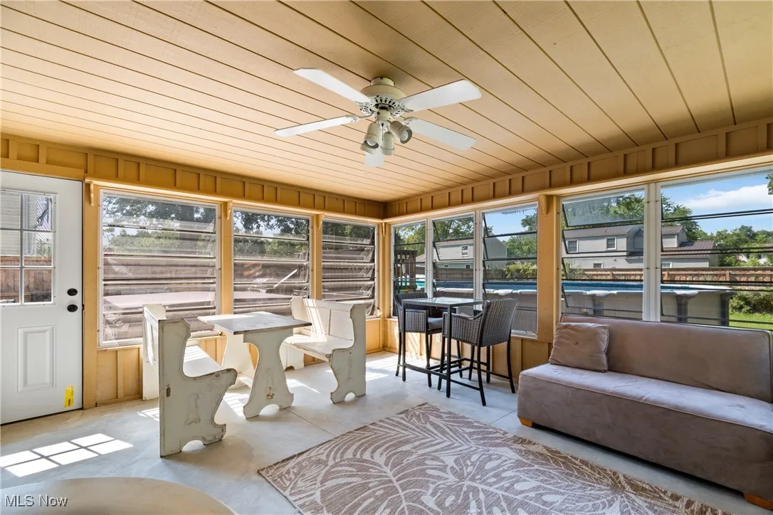 Sunroom featuring a ceiling fan