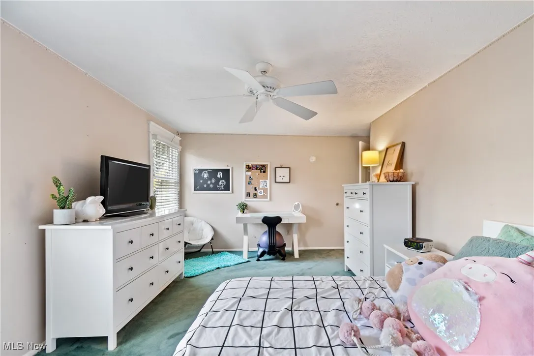 Bedroom with carpet flooring and ceiling fan