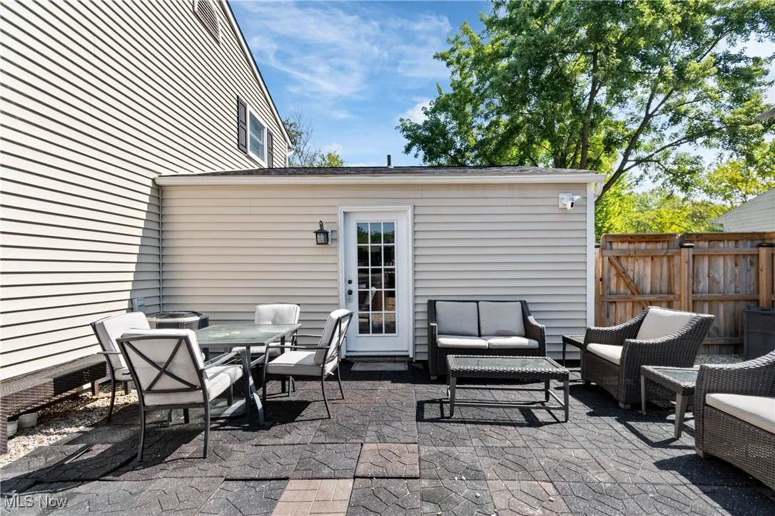 View of patio featuring an outdoor living space, a gate, and outdoor dining space