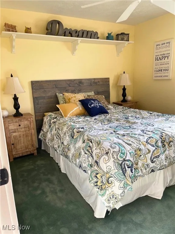 Carpeted bedroom with a textured ceiling