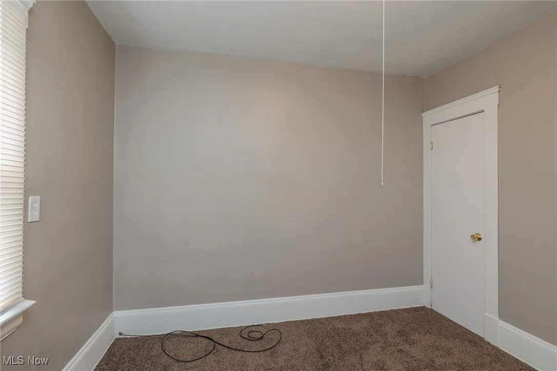Empty room featuring carpet floors and baseboards