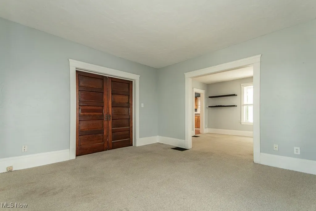 Unfurnished bedroom with carpet flooring and a closet