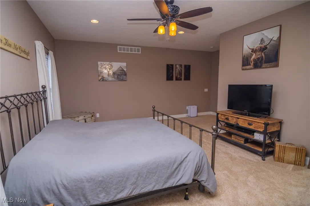 Bedroom featuring carpet flooring, a ceiling fan, and recessed lighting