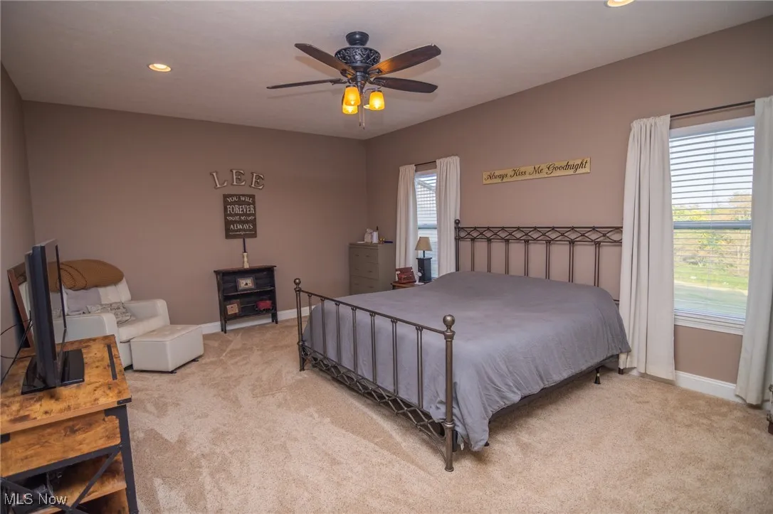 Bedroom featuring light carpet, recessed lighting, and ceiling fan