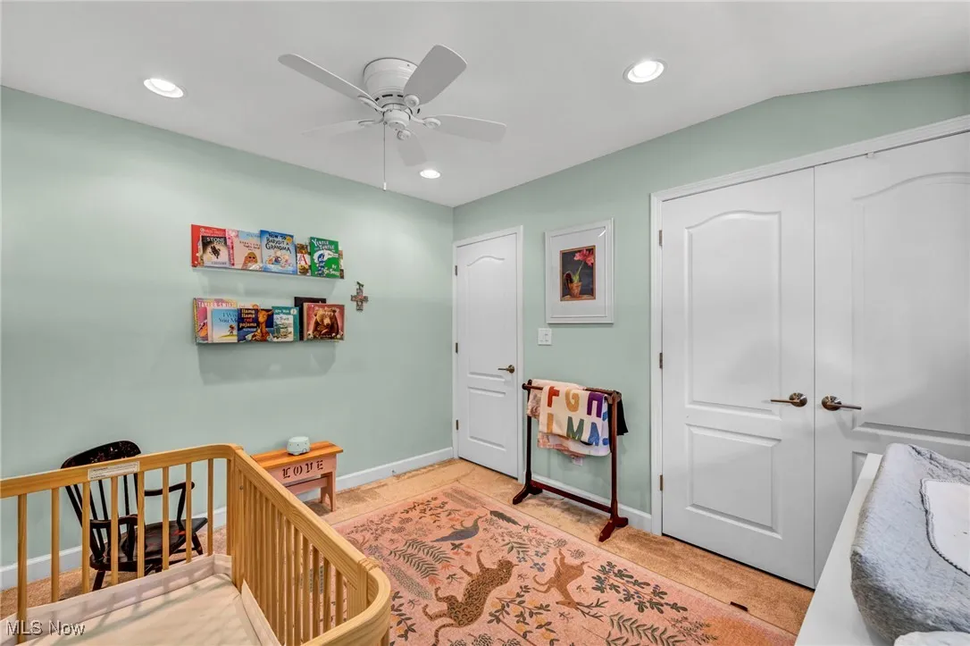 Bedroom with a nursery area, recessed lighting, a closet, and ceiling fan