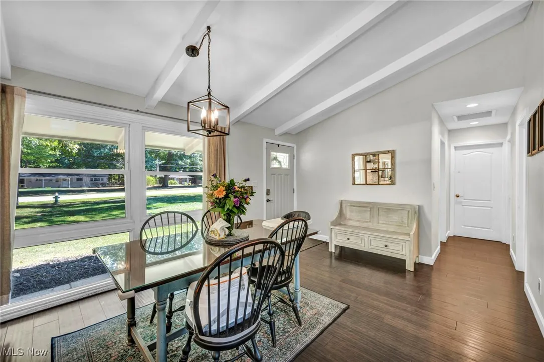 Dining space featuring dark wood finished floors, a chandelier, and recessed lighting