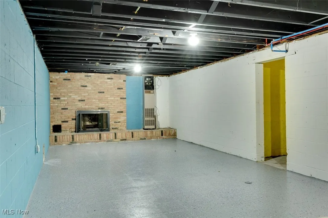 Unfinished basement with a fireplace