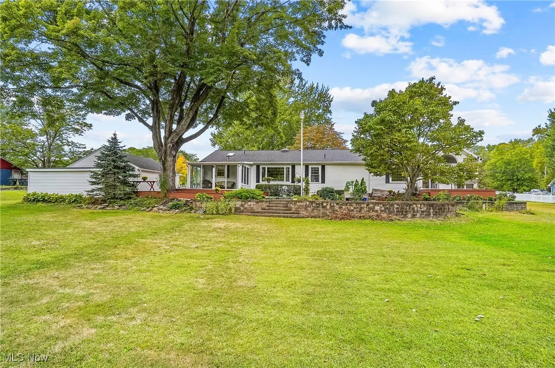 Rear view of property with a lawn