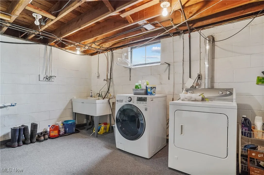 Washroom with washing machine and clothes dryer