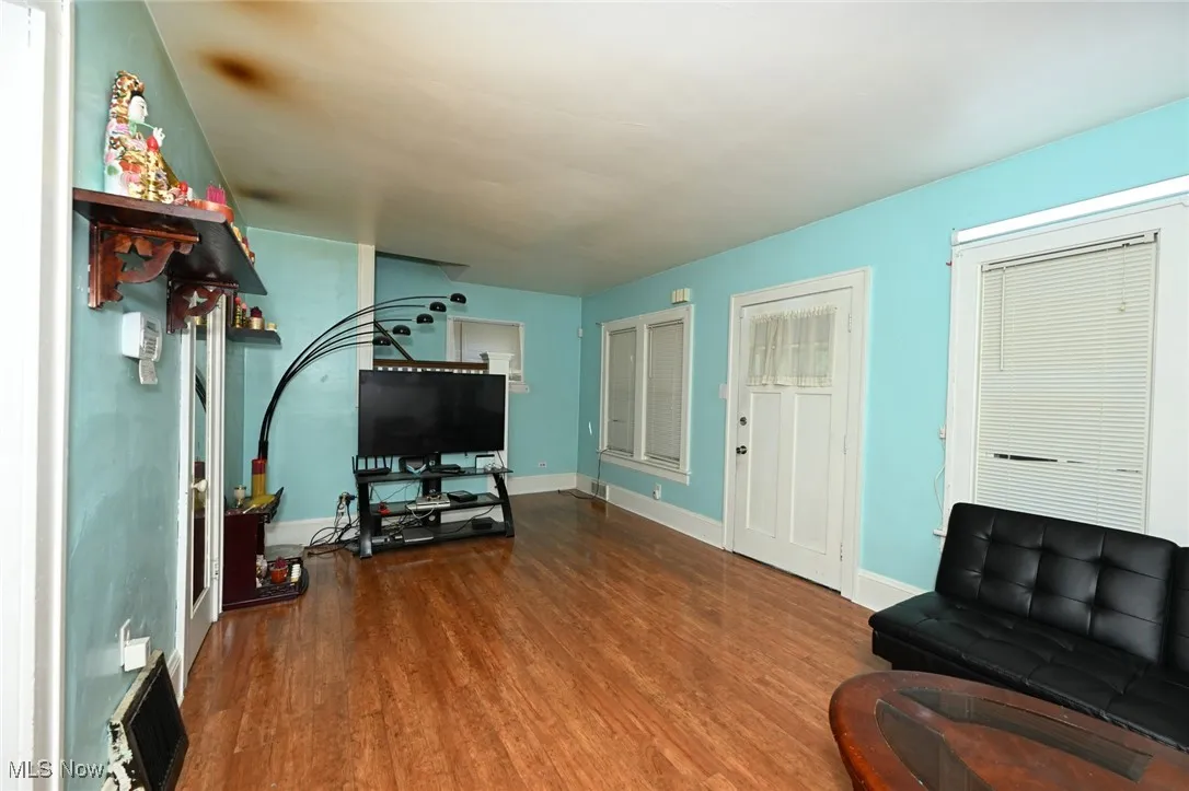 Living area with wood finished floors and baseboards