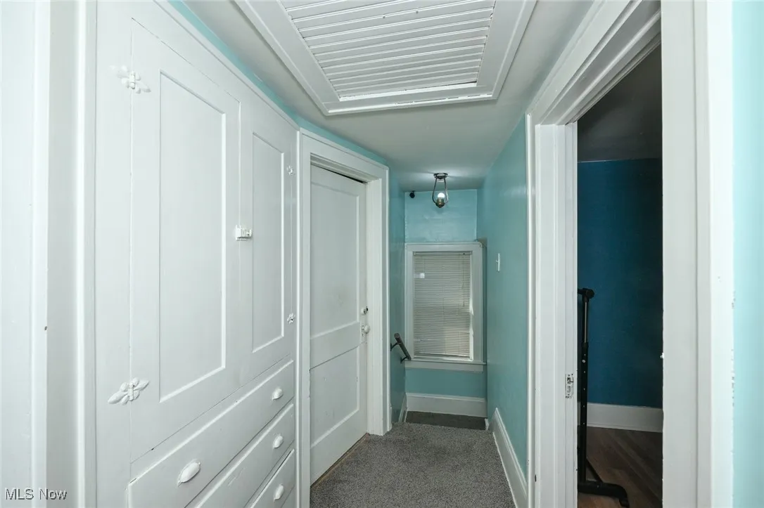 Hall with baseboards and carpet floors