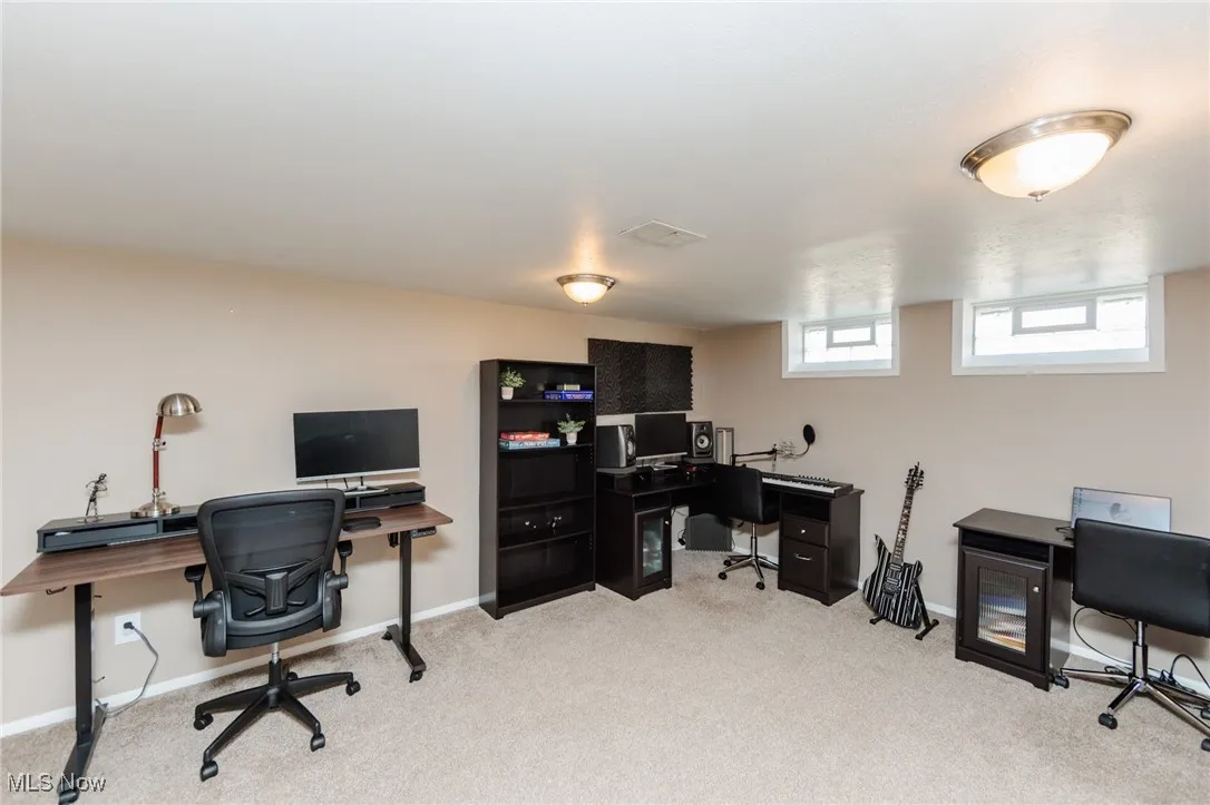 Office area with light carpet and baseboards