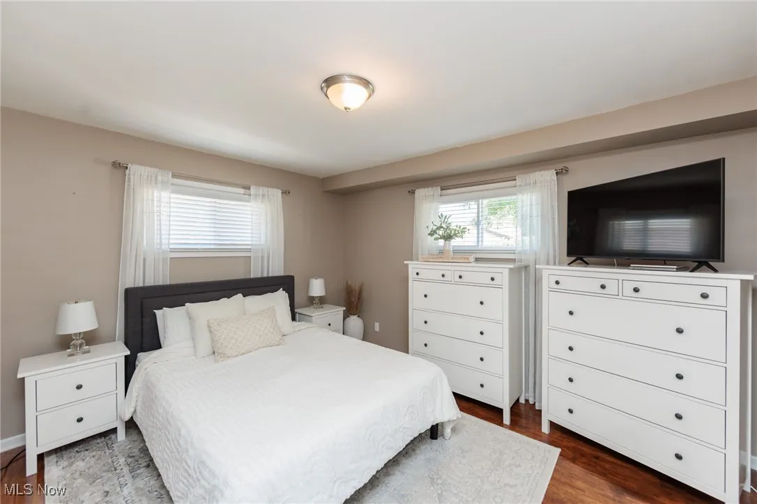Main bedroom with dark wood-style floors