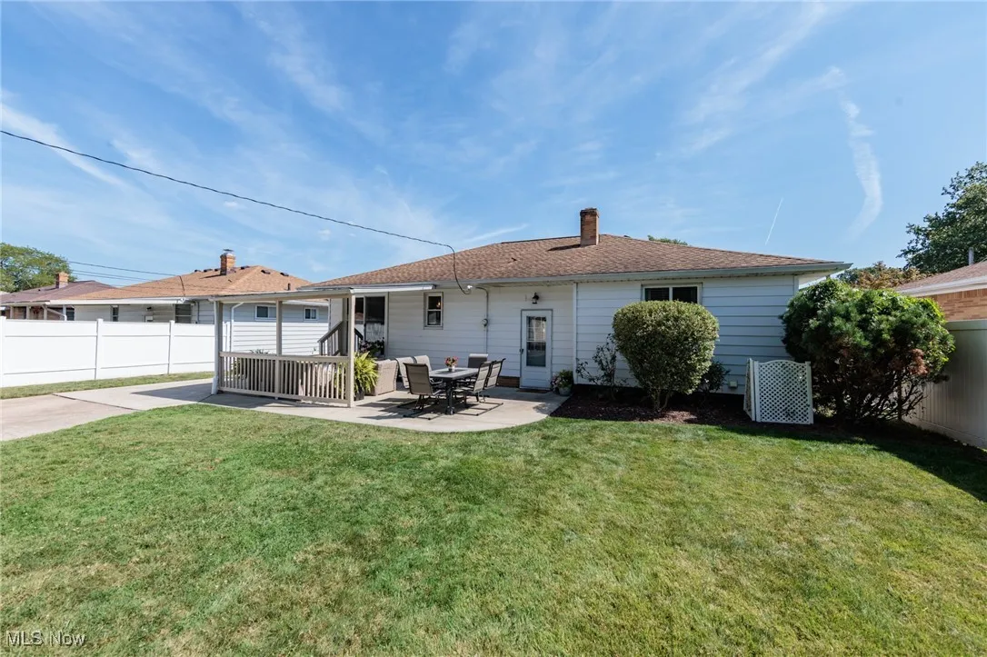 Rear view of property with a patio area and a chimney - fences belong to each neighbor not this home
