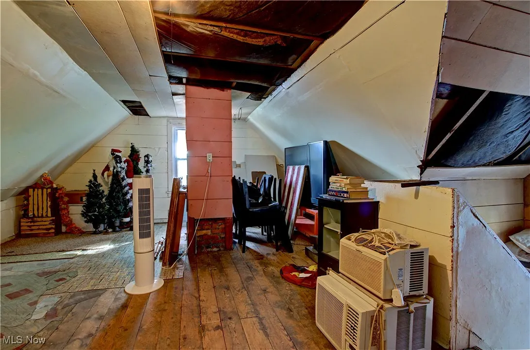 Bonus room featuring hardwood / wood-style floors and lofted ceiling