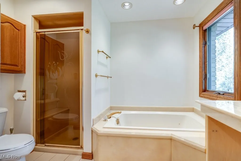 Loqwe lwcwl Bathroom featuring a bath, a shower stall, vanity, light tile patterned flooring, and recessed lighting