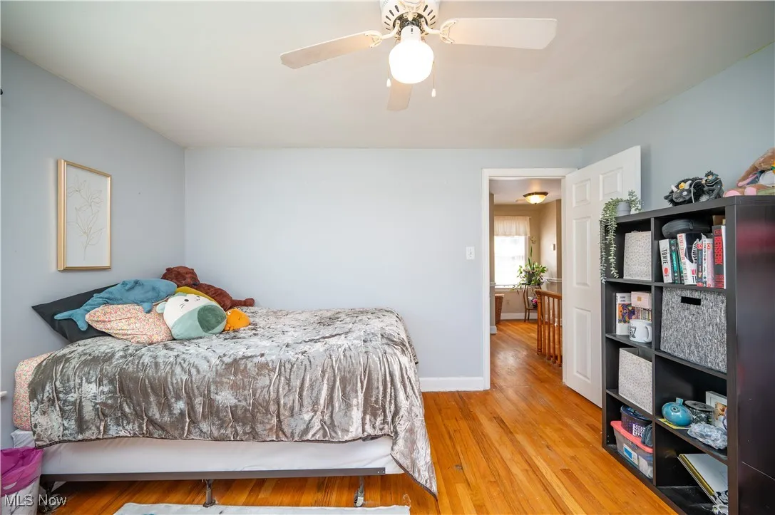Bedroom with wood finished floors and ceiling fan