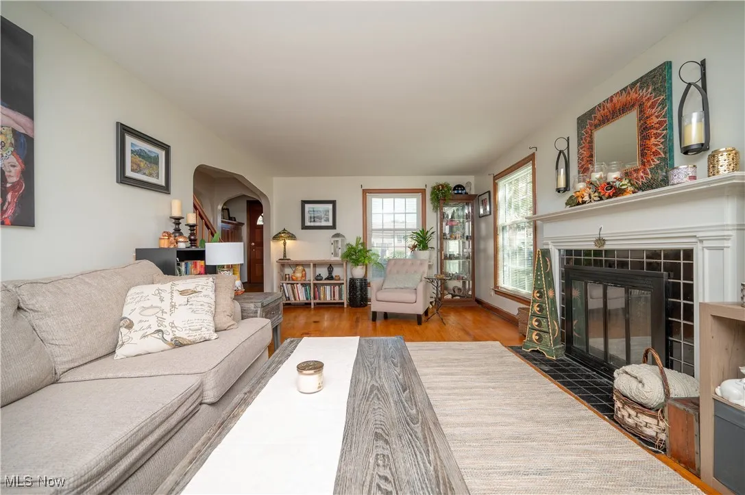Living room, wood-type flooring, and a tile fireplace