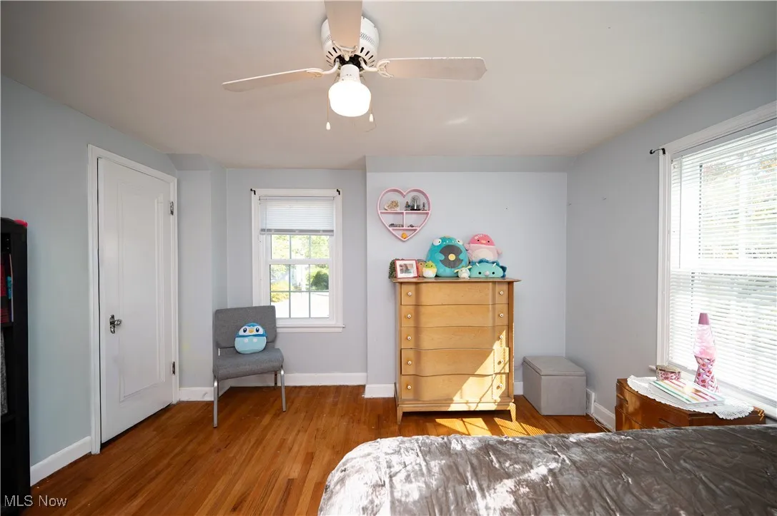 Bedroom with wood finished floors and a ceiling fan