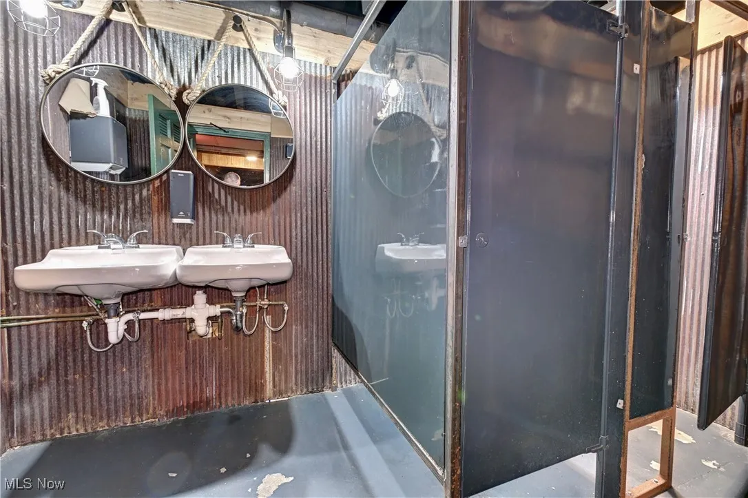 Full bath featuring concrete floors and a sink