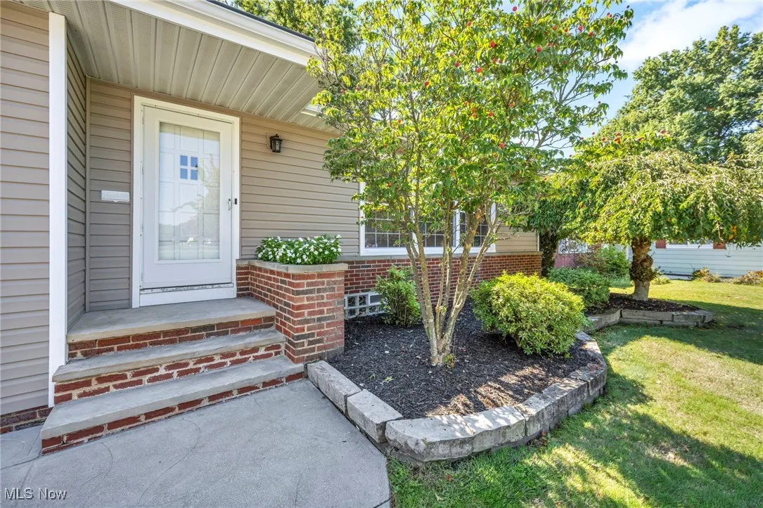Entrance to property featuring a lawn