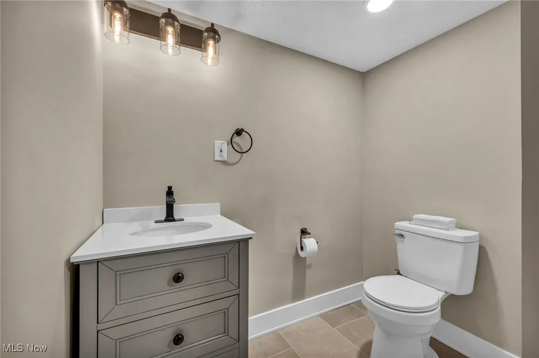 Bathroom featuring vanity, light tile patterned floors, and recessed lighting