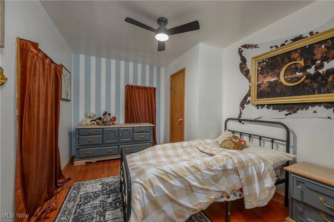 Bedroom featuring dark wood-style flooring and ceiling fan