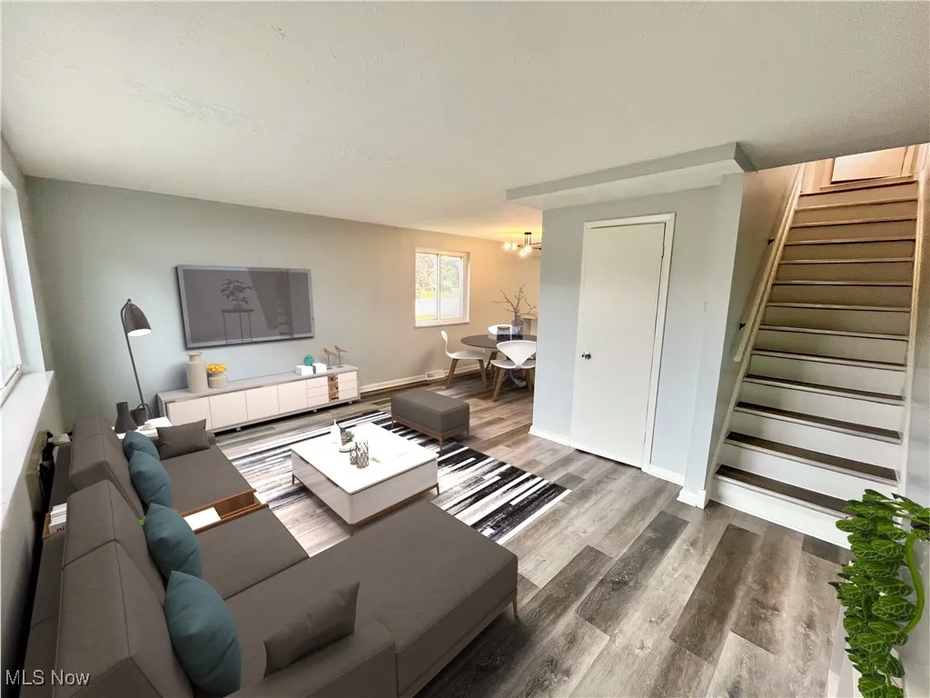 Living area featuring stairway and wood finished floors