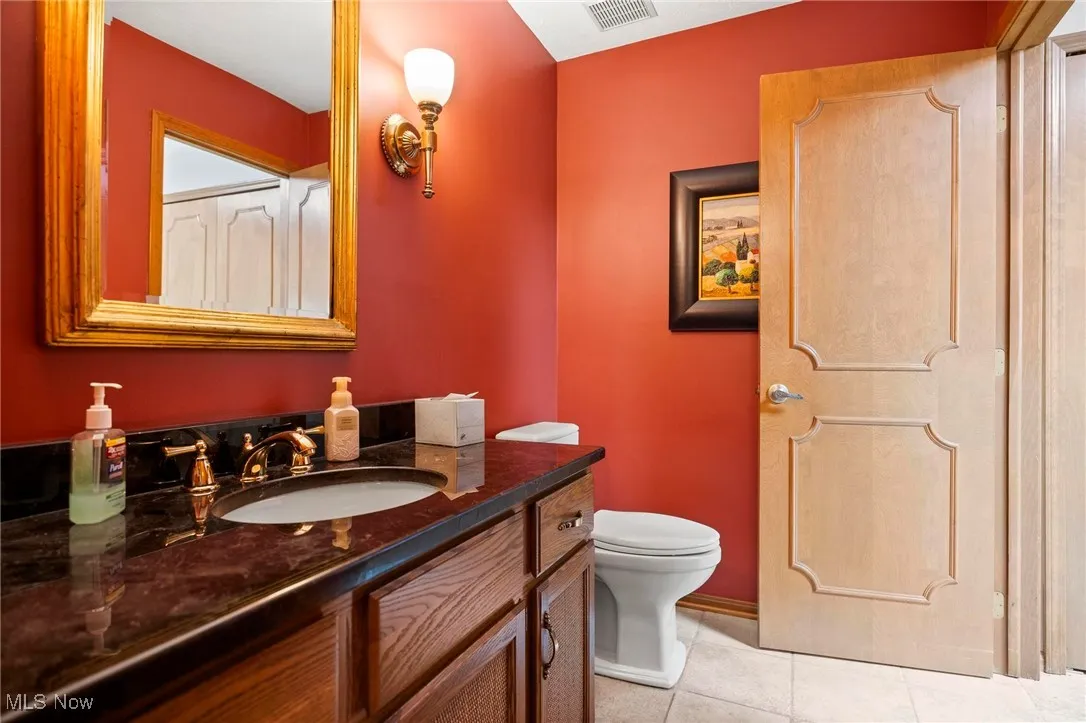 Bathroom featuring light tile patterned floors and vanity