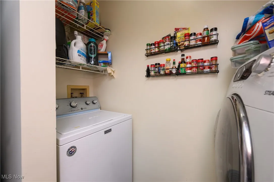 Washroom featuring washing machine and dryer