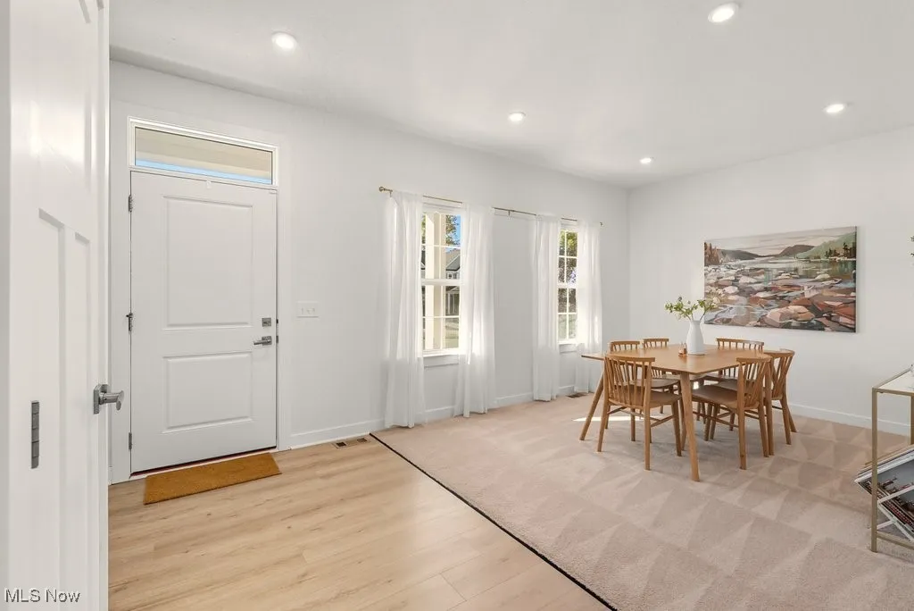 Dining space featuring recessed lighting and light wood-style flooring