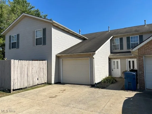 View of home's exterior featuring concrete driveway