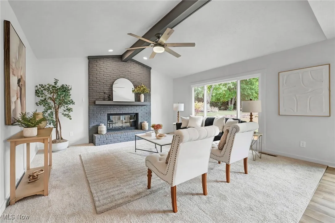 Living room with a fireplace and ceiling fan