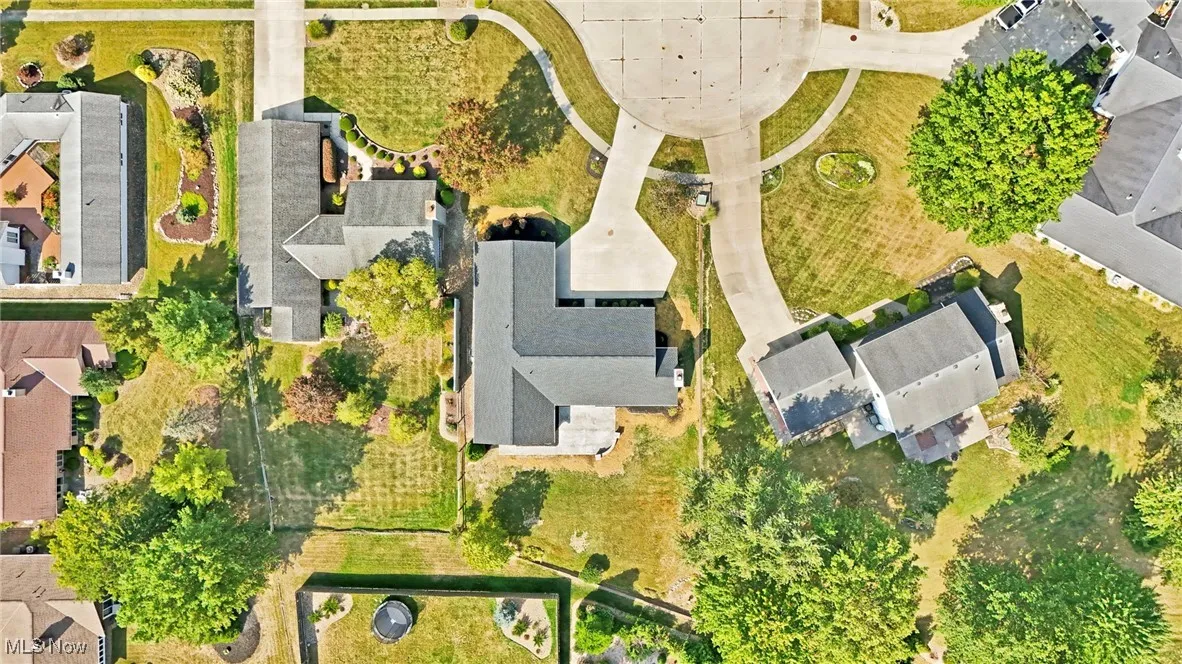 Aerial view of property and surrounding area featuring nearby suburban area