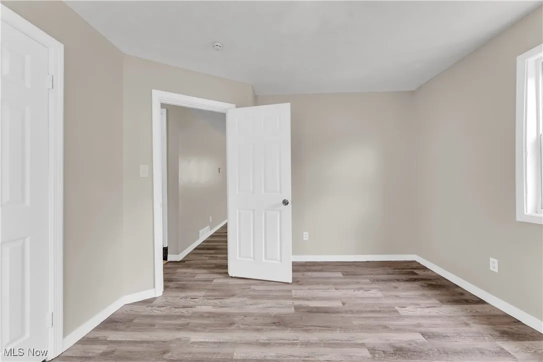 Unfurnished bedroom with light wood-type flooring and baseboards