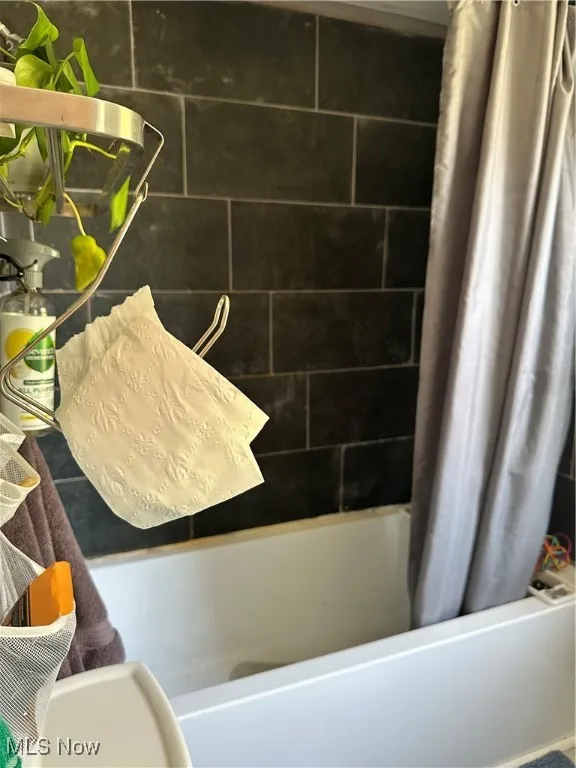 Full bathroom with shower / bath combo with shower curtain