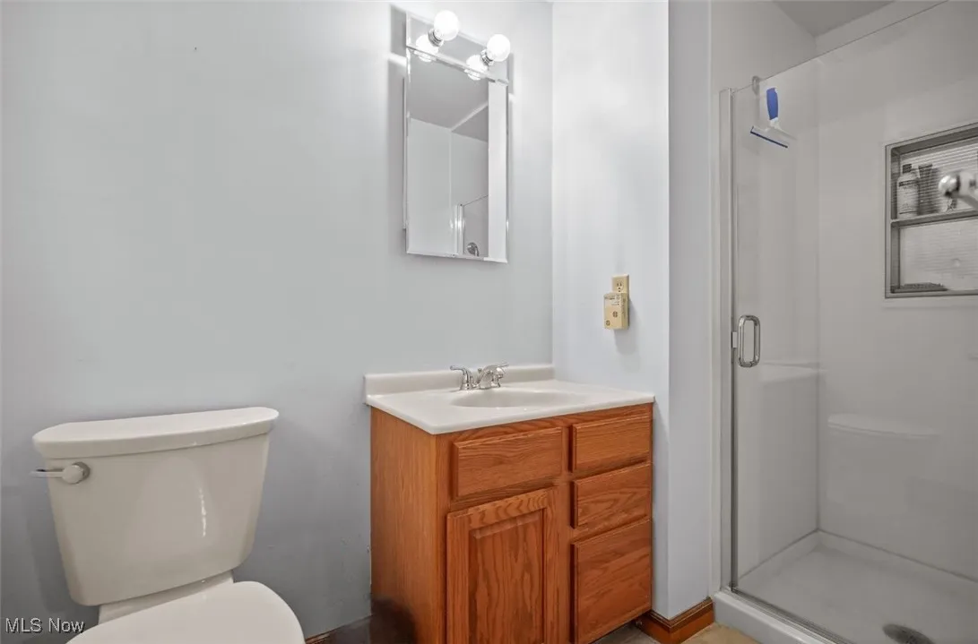 Full bathroom featuring a shower stall and vanity