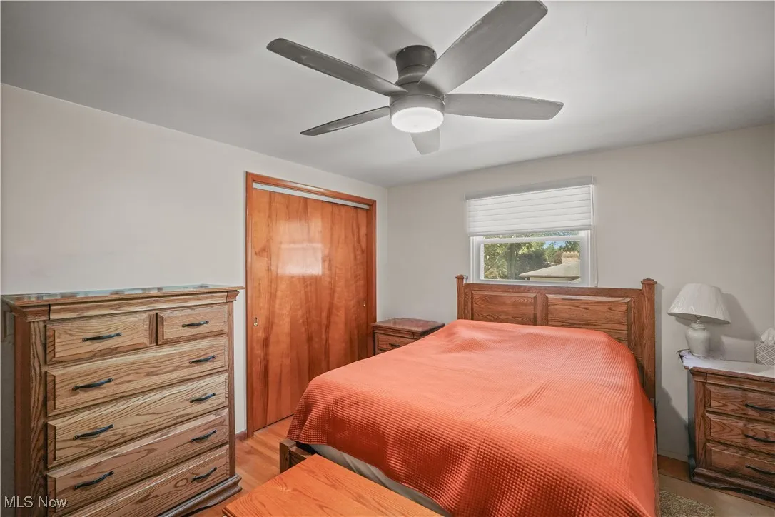 Bedroom featuring a closet, light wood-style floors, and ceiling fan