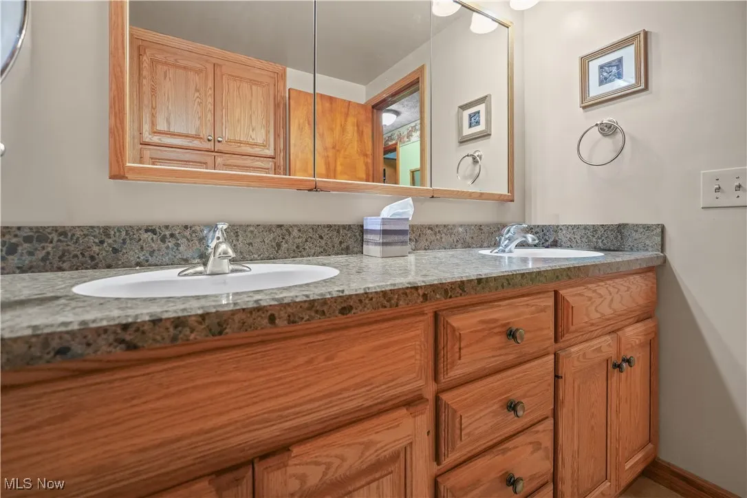 Full bath featuring double vanity