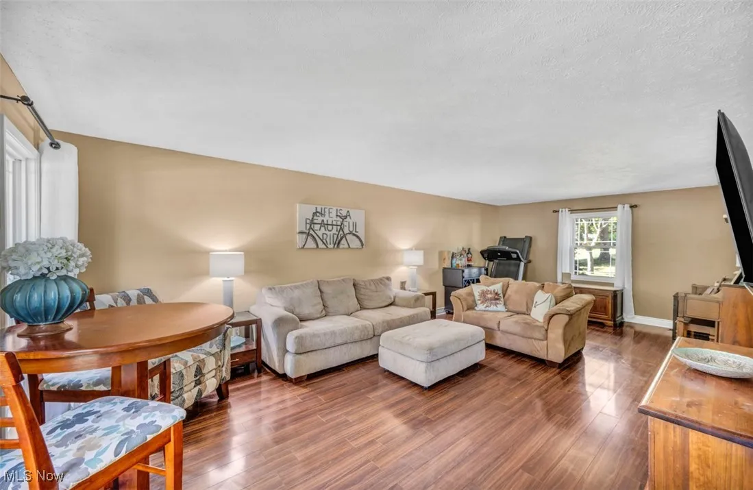 Living room with wood finished floors and a textured ceiling