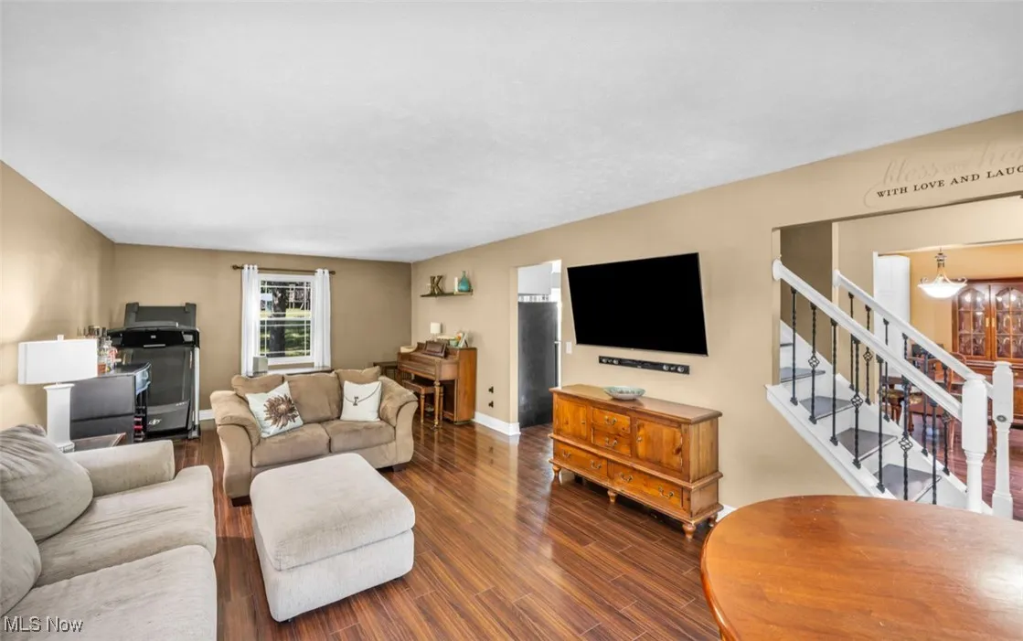 Living area with wood finished floors and stairs