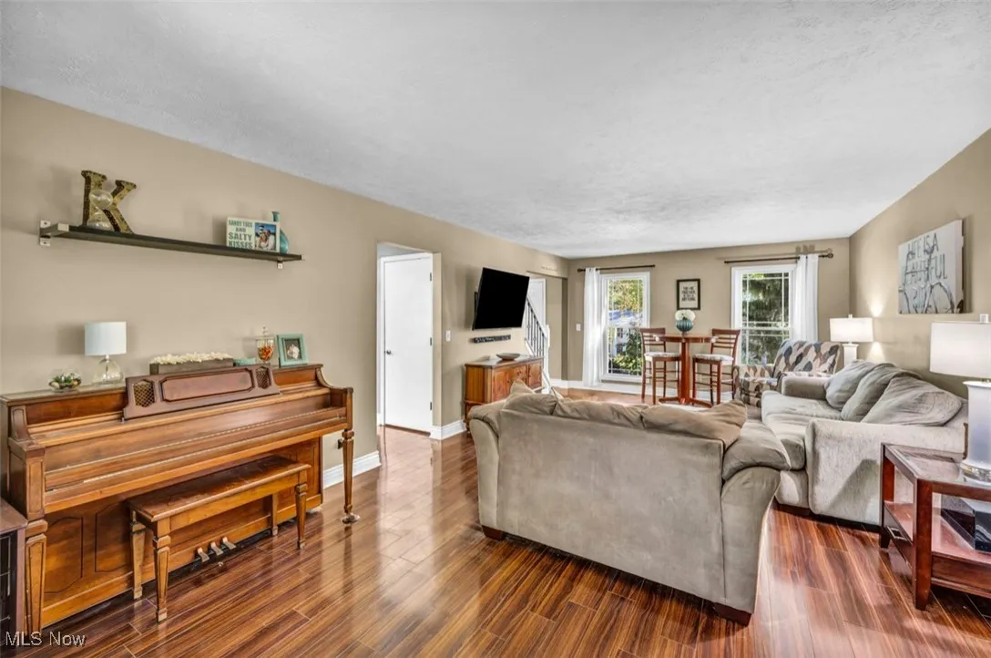 Living room with wood finished floors and a textured ceiling