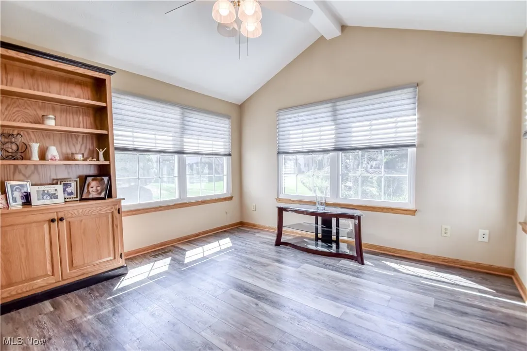 Unfurnished office with plenty of natural light, light wood-type flooring, and a ceiling fan