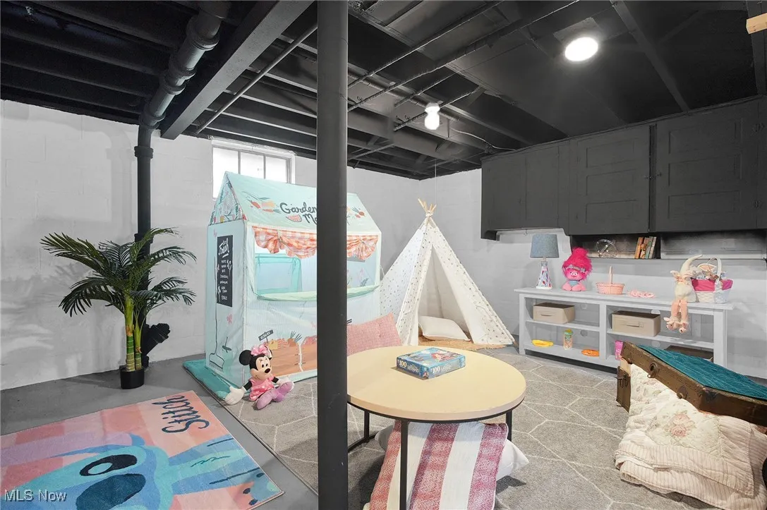Playroom featuring finished concrete floors