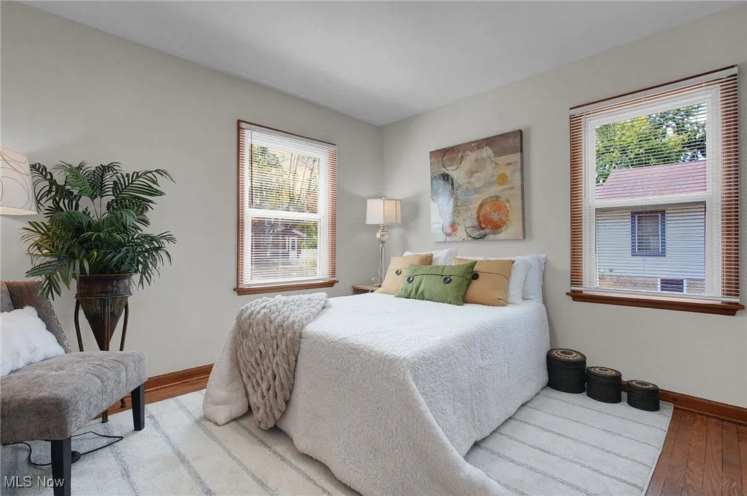 Bedroom featuring multiple windows and wood finished floors