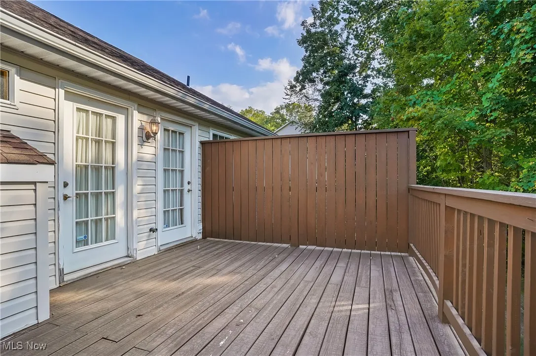 View of wooden deck/terrace off great room and primary bedroom