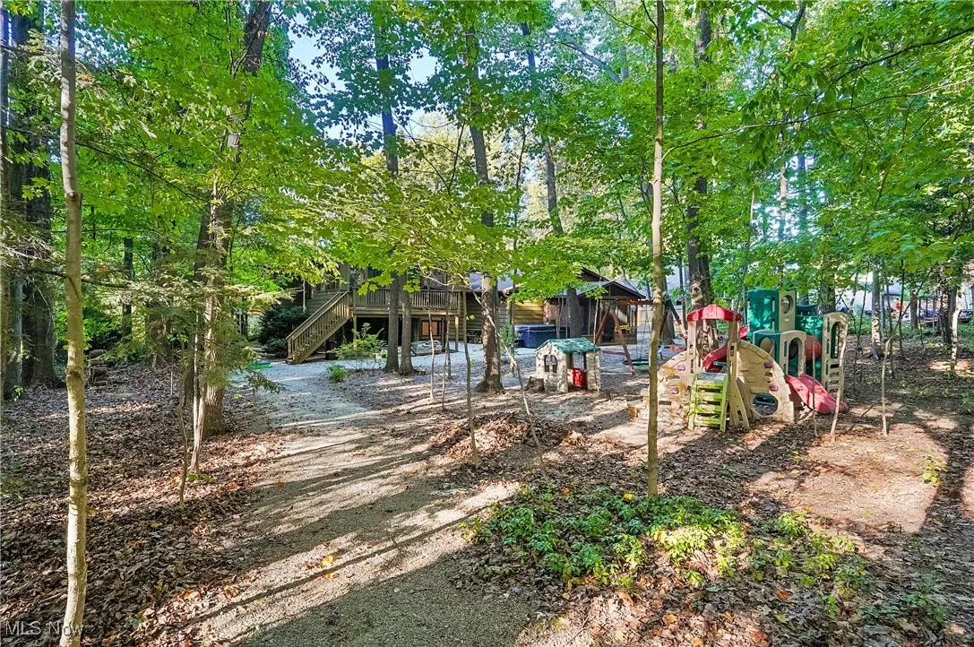 View of yard with stairs and a playground